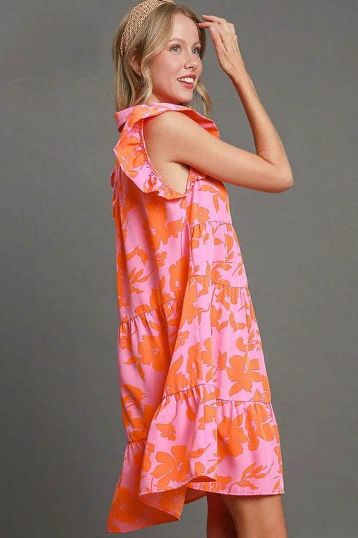 Back view of a sleeveless pink dress with vibrant orange floral prints and ruffled sleeves